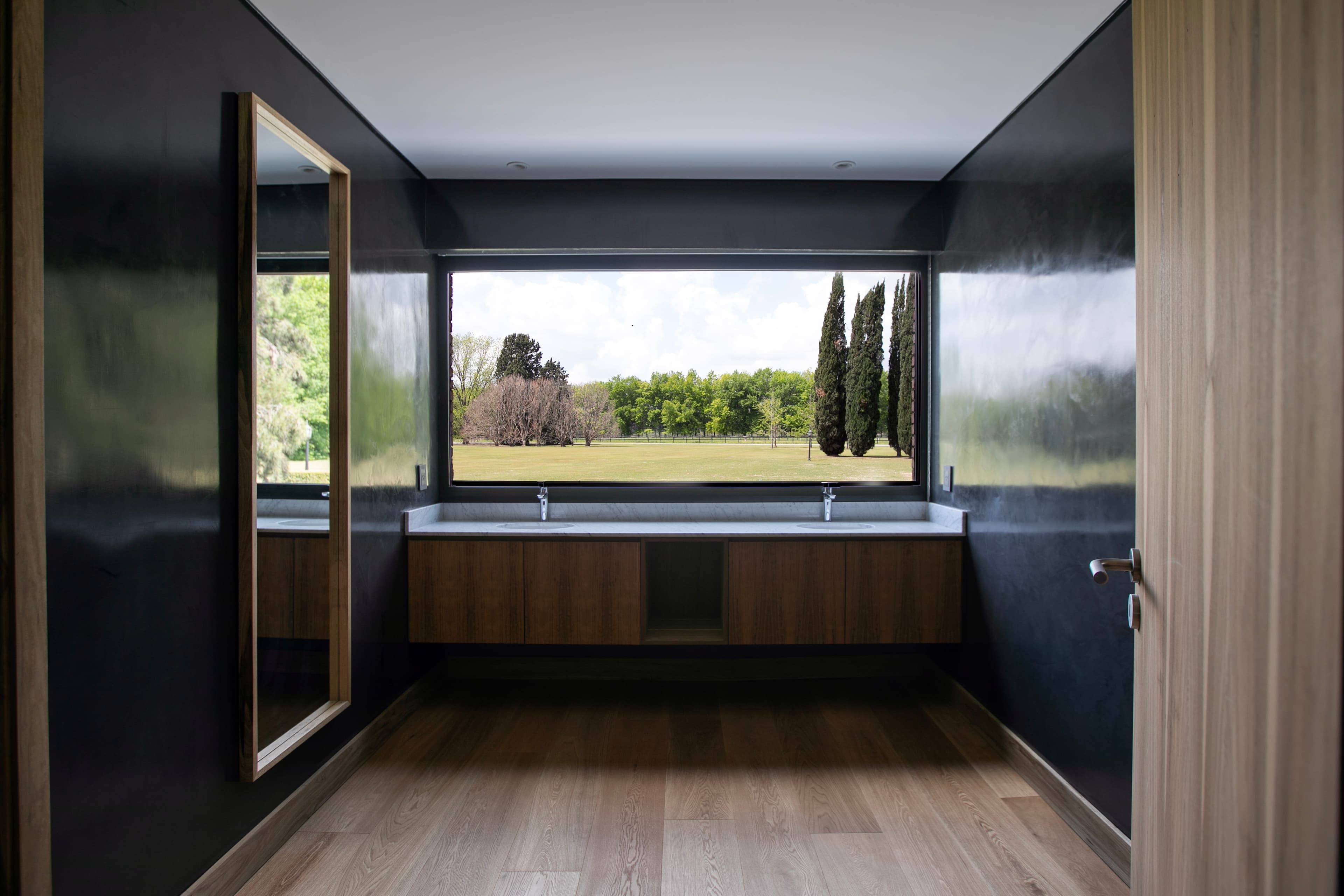 Modern interior design with teal sofa and concrete stairs